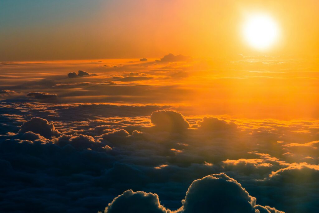 pexels-photo-355508-355508 Stunning aerial view of a dramatic sunset over thick clouds, glowing horizon.